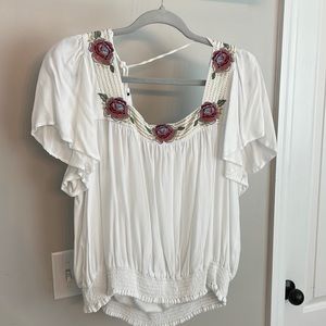 White top with floral detail